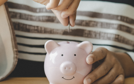A person holding a piggy bank.