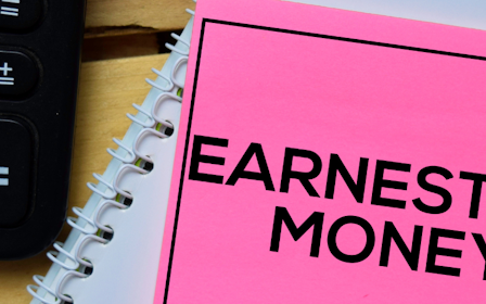 A pink notepad next to a keyboard and a remote control.