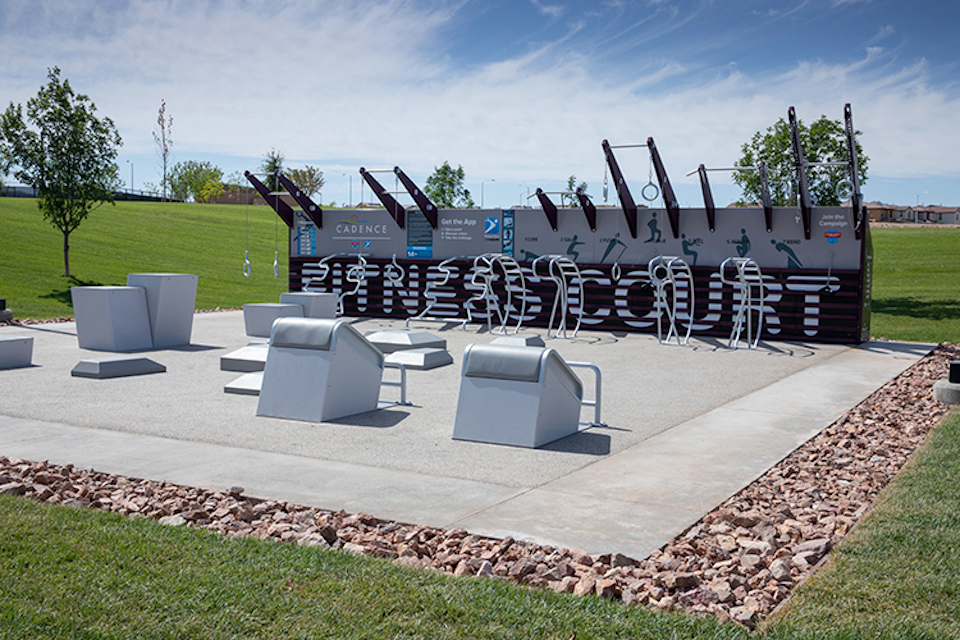 A group of white chairs in a circle on a stone surface.