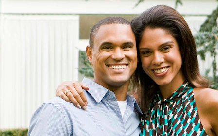 A man and woman smiling.