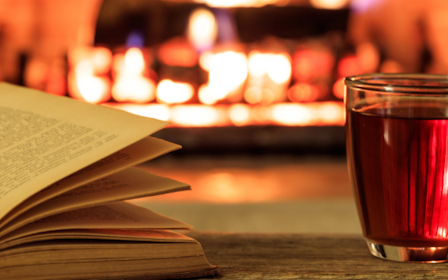 A book and a glass of liquid.
