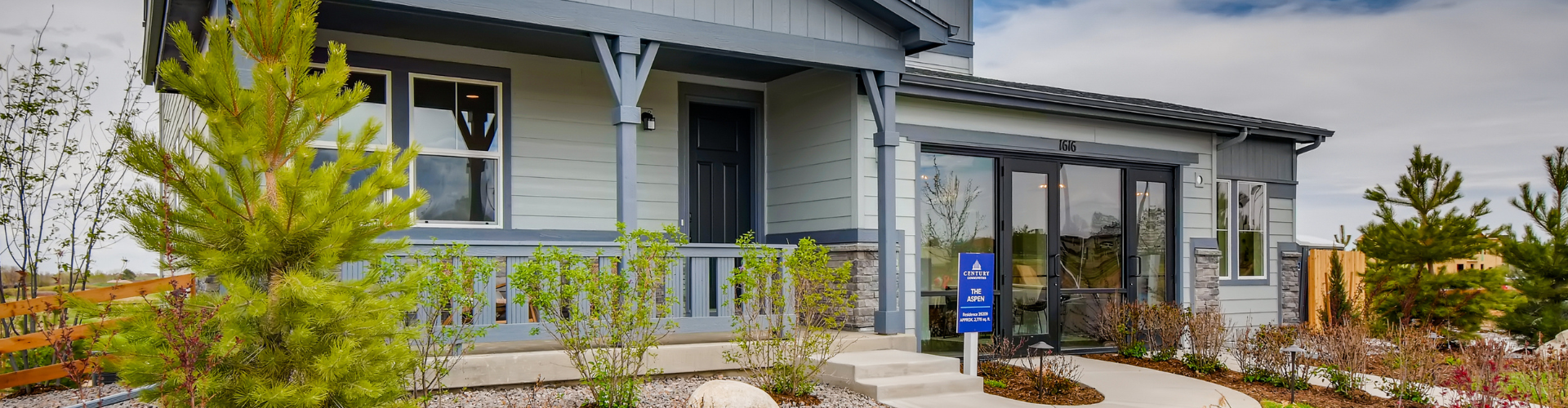 A building with trees and bushes in front of it.