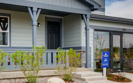 A building with trees and bushes in front of it.