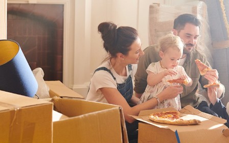 A group of people eating pizza.