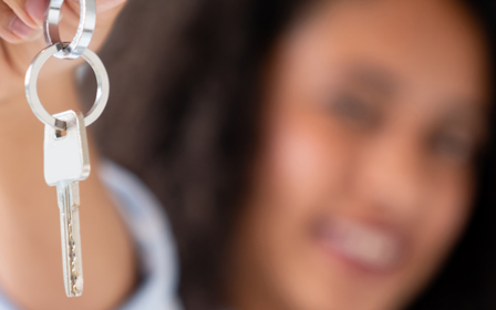 A woman holding a key.