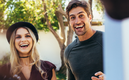 A man and woman smiling.