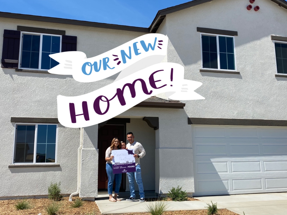 Happy Homeowner - Our New Home! A group of people standing in front of a building with a sign.