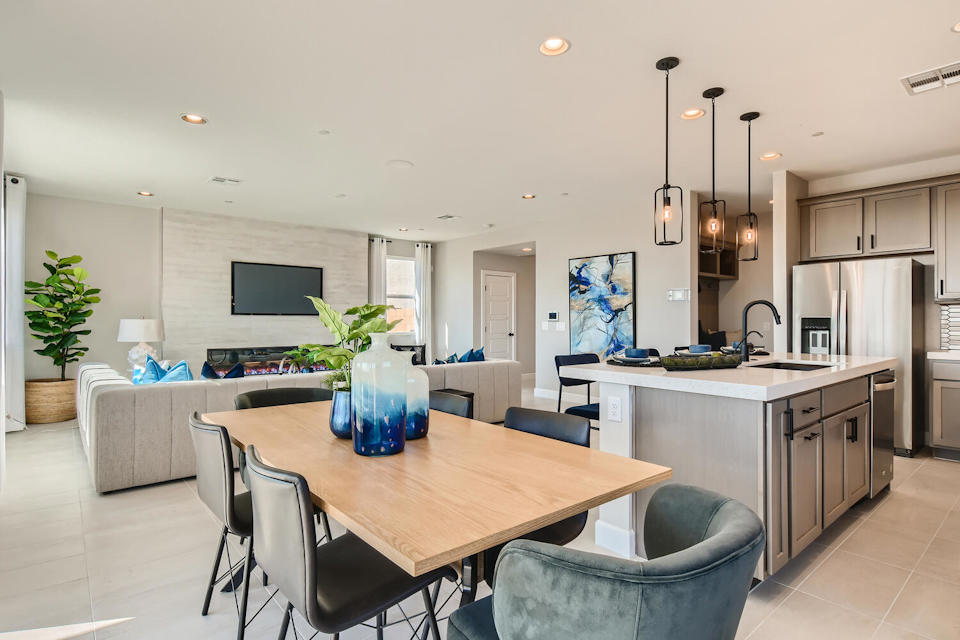 A kitchen with a table and chairs.