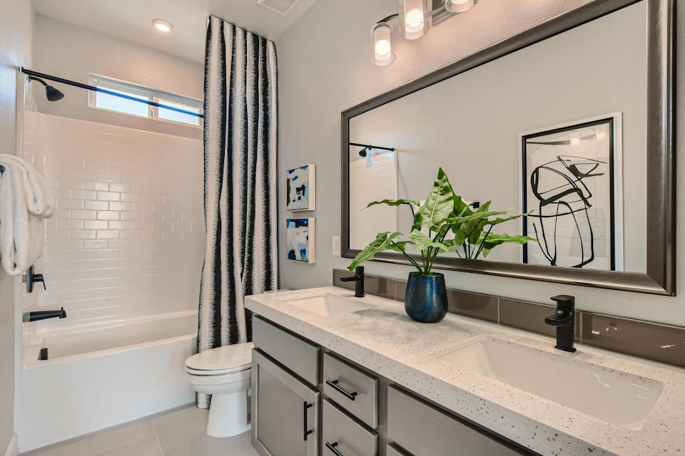 A bathroom with a large mirror.