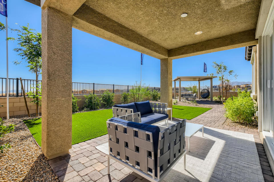 A deck with a couch and a pool.