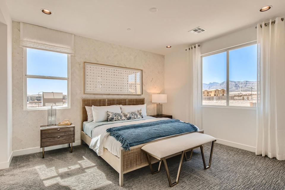 A bedroom with a large window.