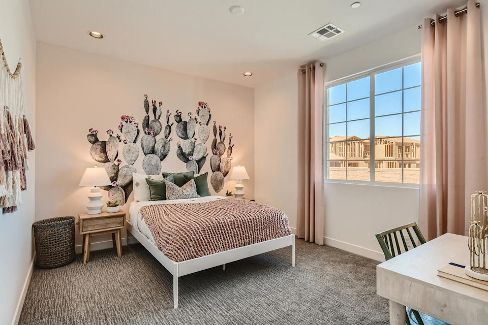 A bedroom with a bed and a window.