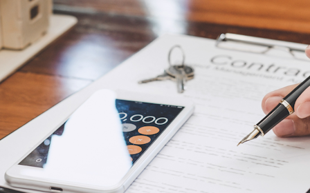 A person writing on a piece of paper.