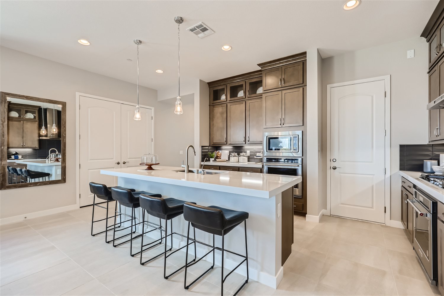 A kitchen with a bar and stools.