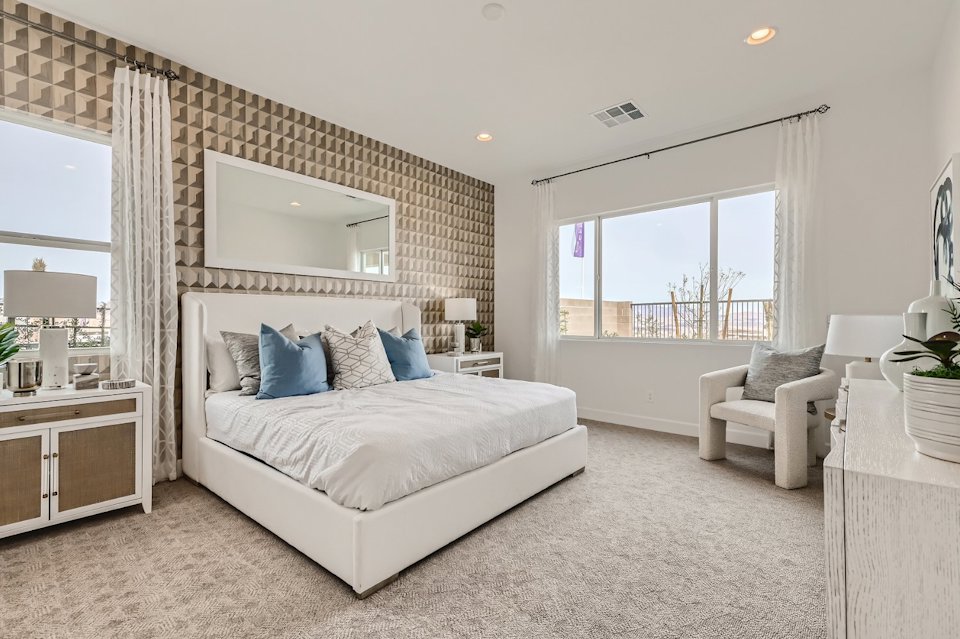 A bedroom with a large window.