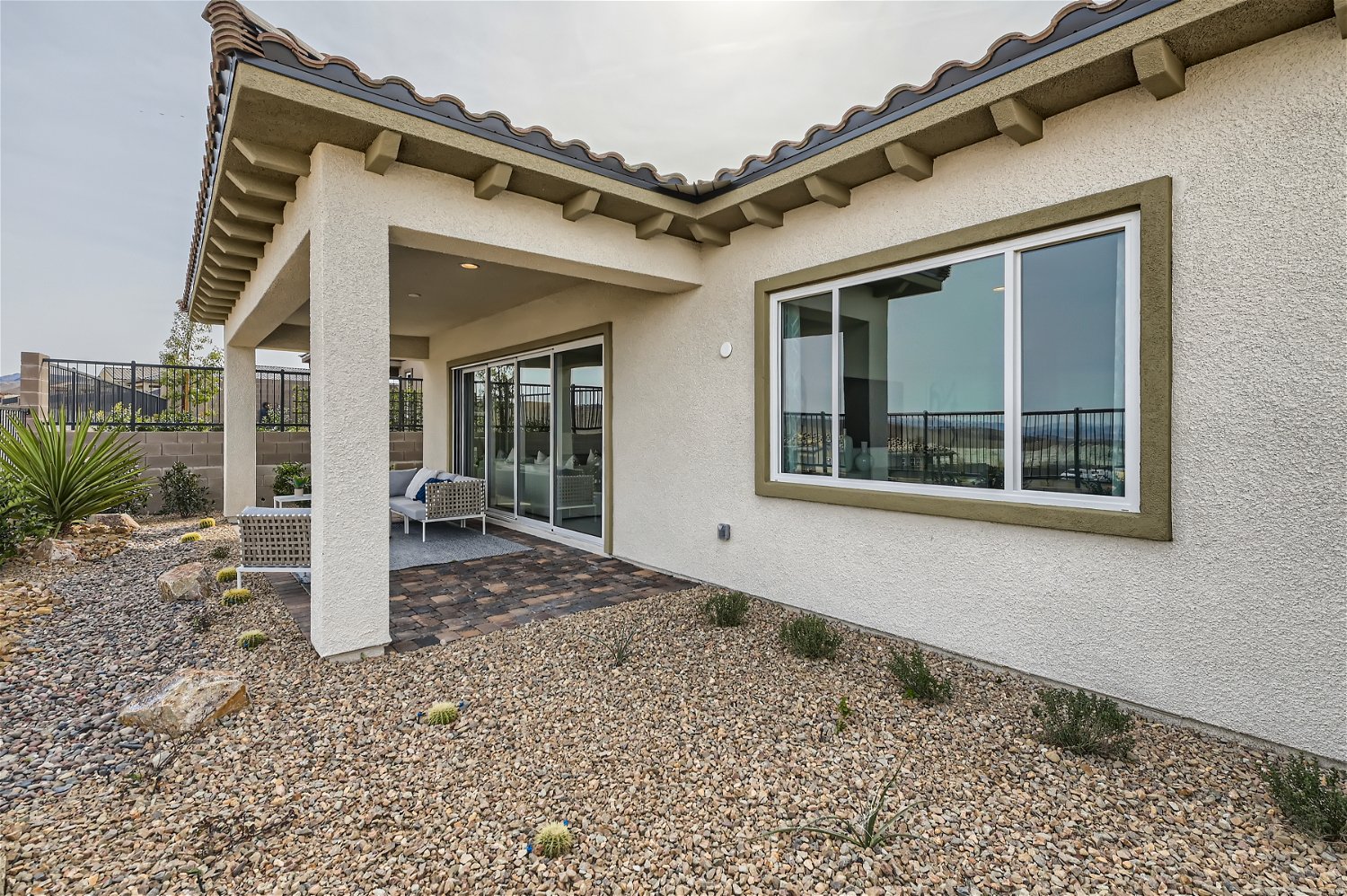A house with a patio and a large glass door.