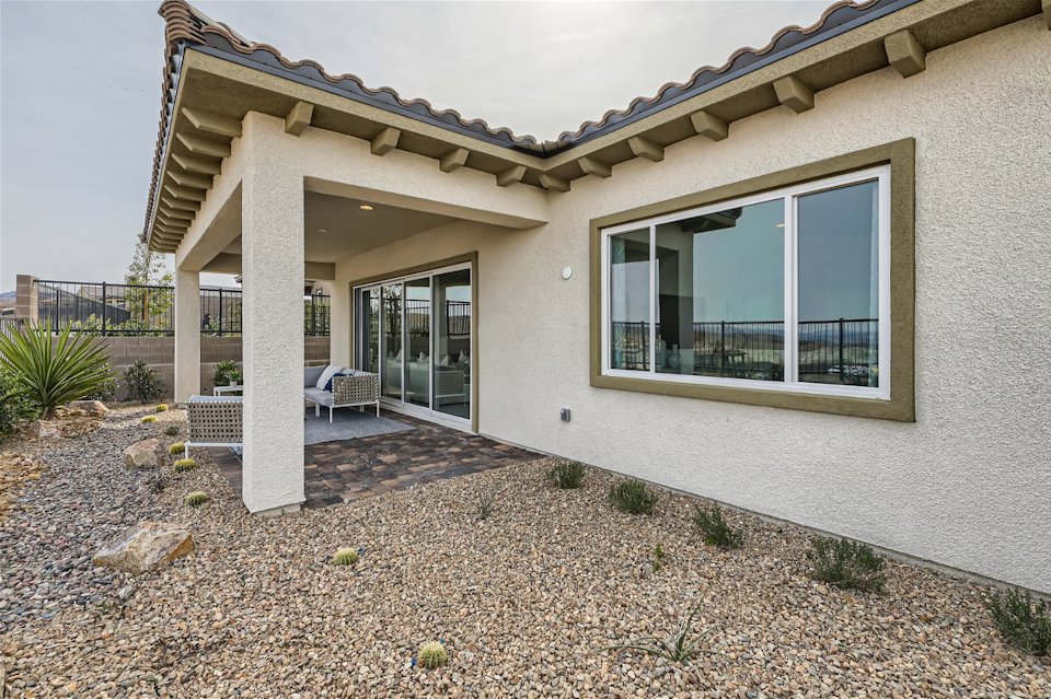 A house with a patio and a large glass door.