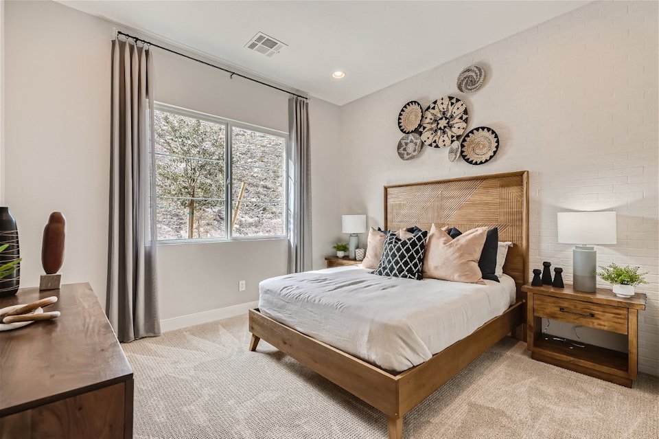 A bedroom with a bed and a desk.