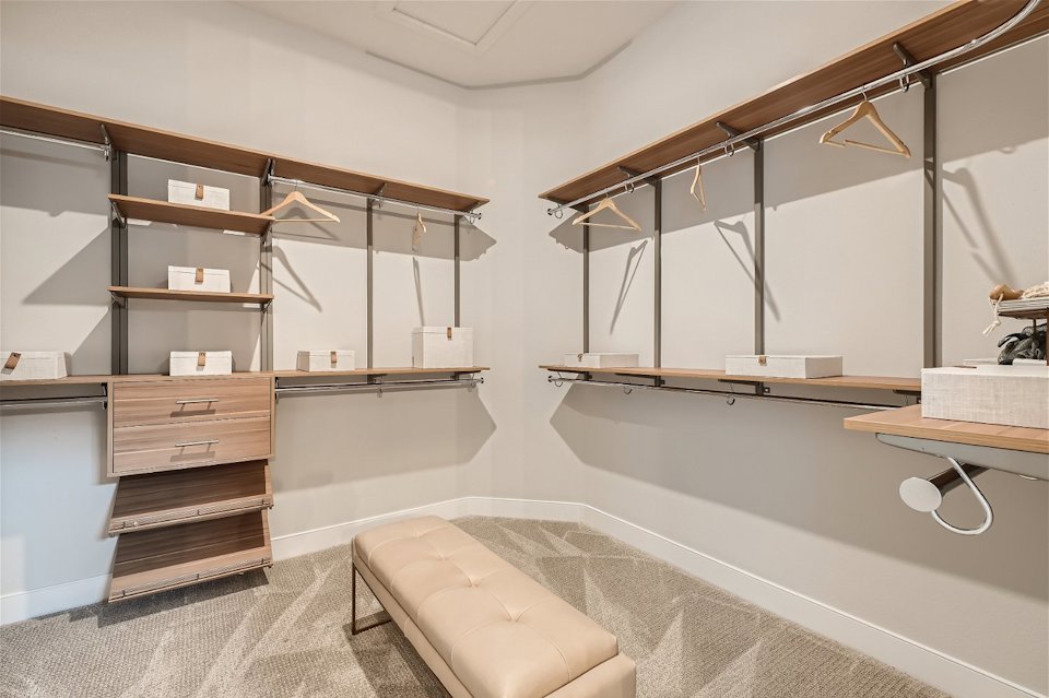 A modern bedroom with a large mirror.