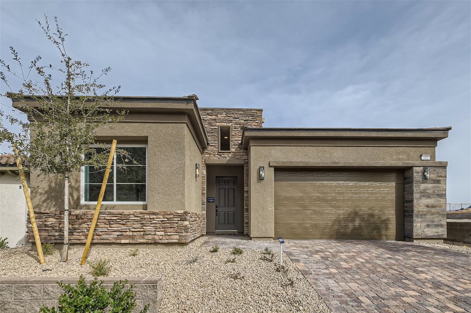 A house with a tree in the front.