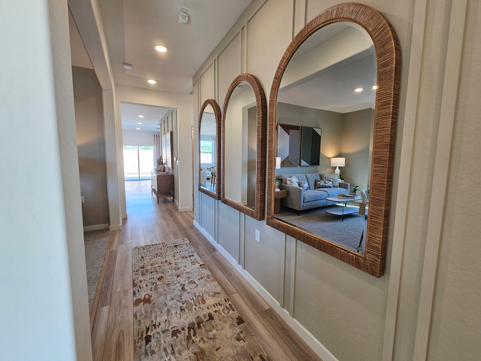 A large bedroom with a large mirror.