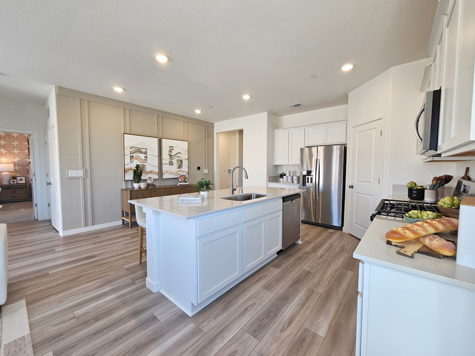 A kitchen with white cabinets.