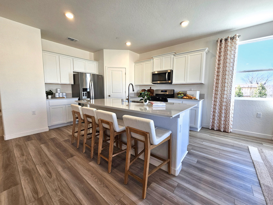 A kitchen with a dining table.
