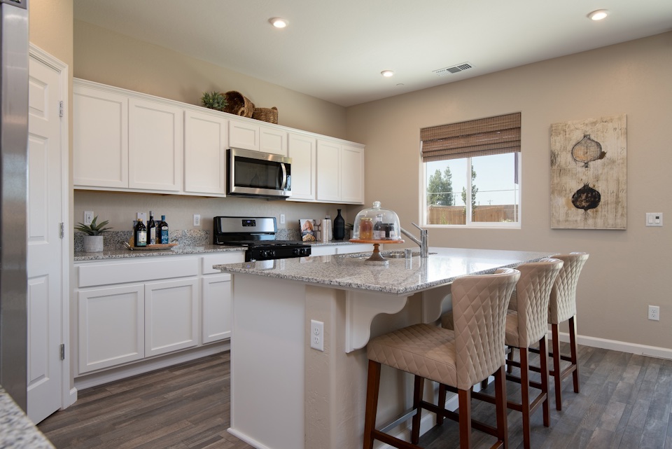 A kitchen with white cabinets.