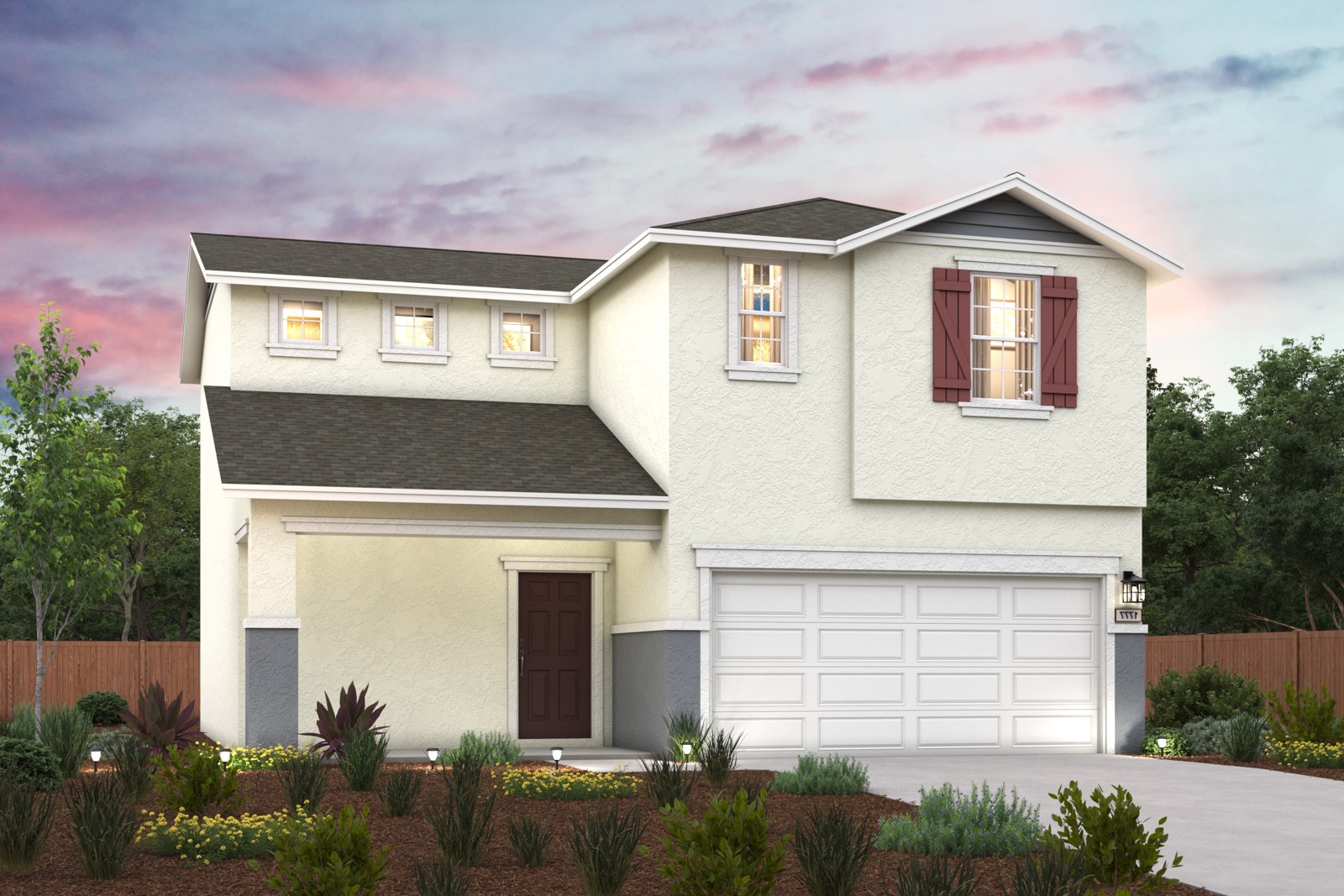 A house with a garage and bushes in front of it.