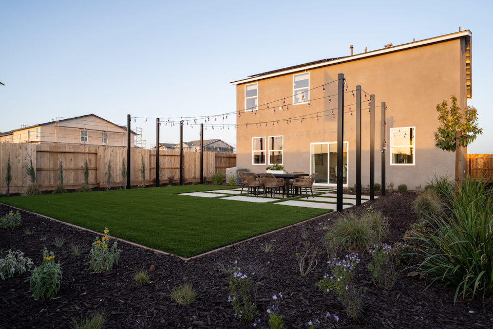 A backyard with a table and chairs.