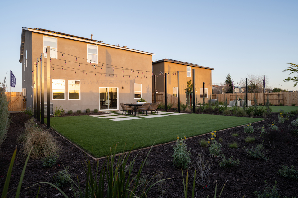A building with a lawn and a table in front of it.