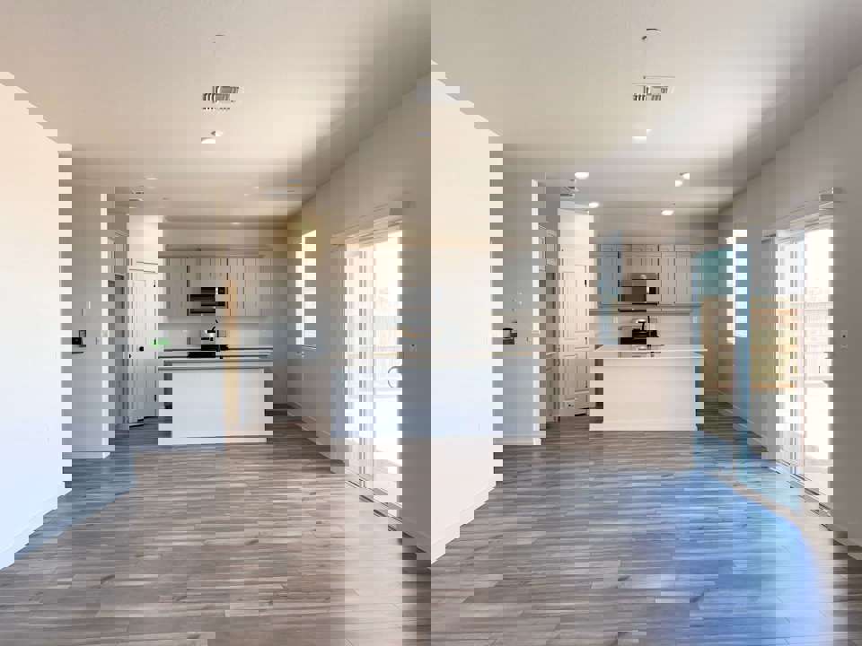 A large kitchen with white cabinets.