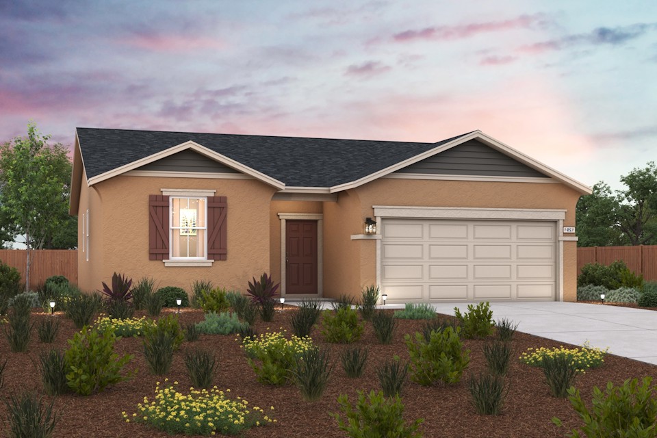 A house with a garage and plants in the front.