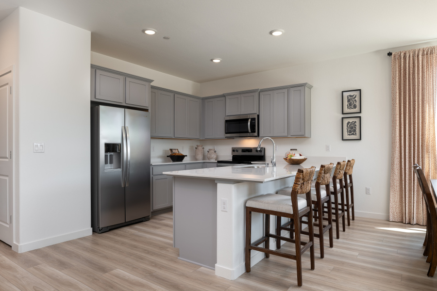 A kitchen with white cabinets.