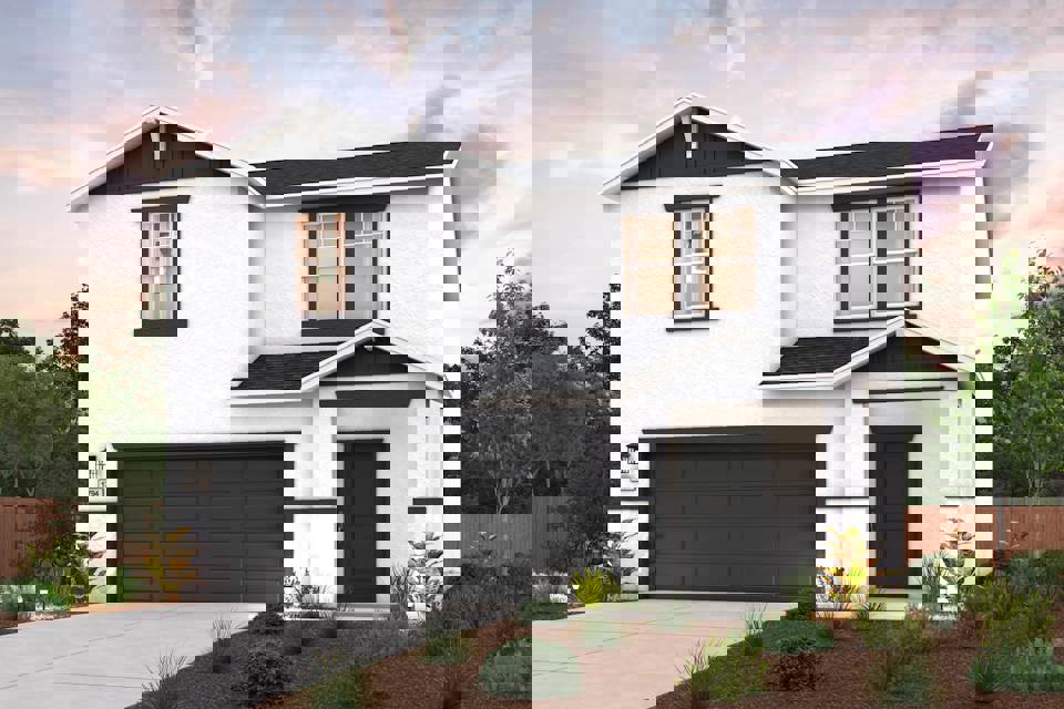 A white house with a garage.