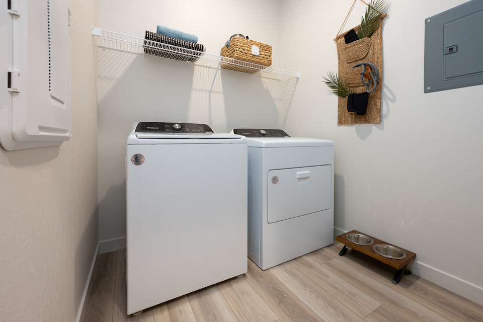 A kitchen with a washer and dryer.
