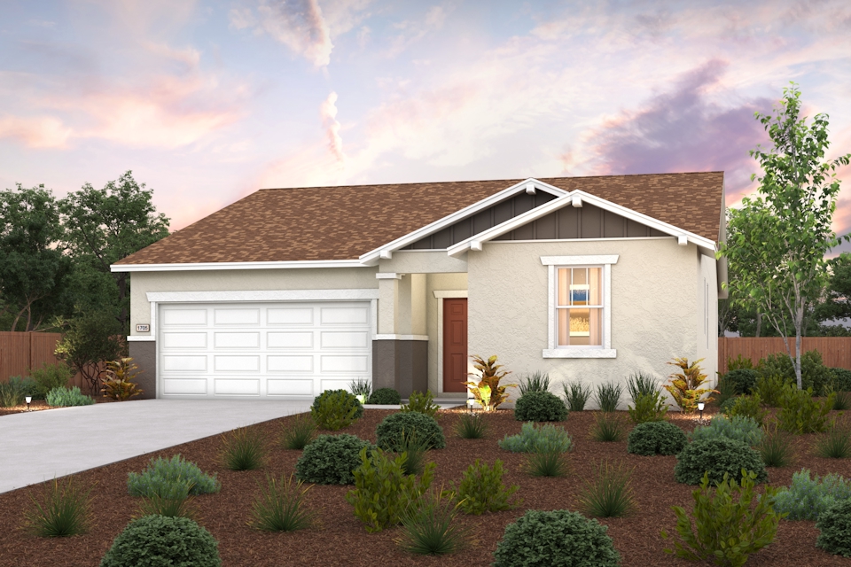 A house with a driveway and bushes.