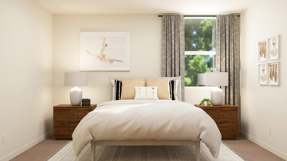 A bedroom with a bed and lamps.