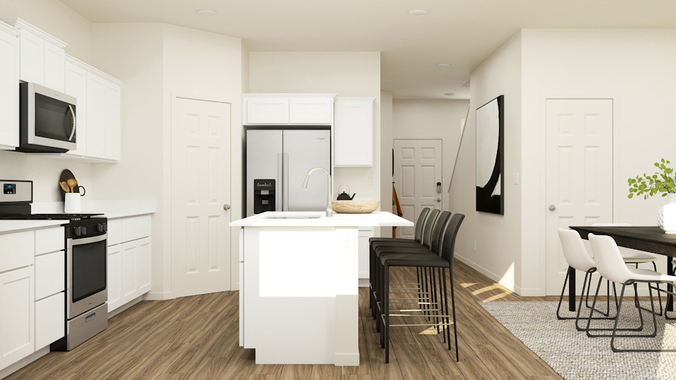 A kitchen with white cabinets.