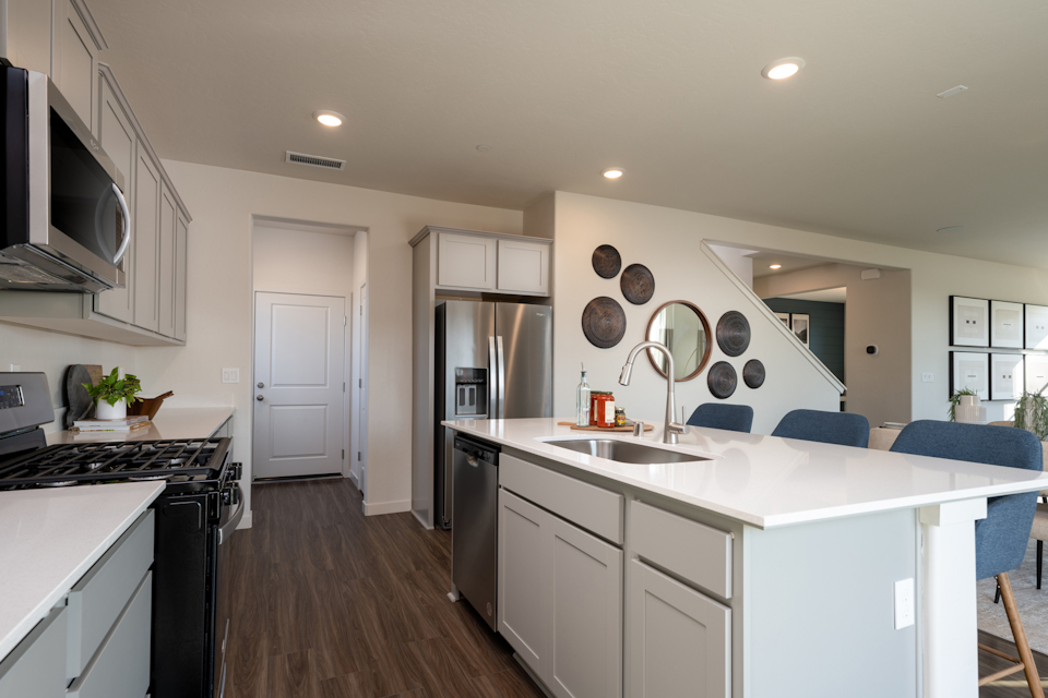 A kitchen with white cabinets.