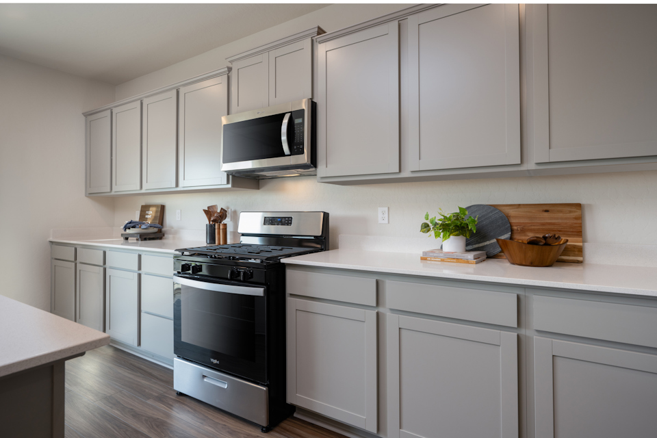 A kitchen with white cabinets.