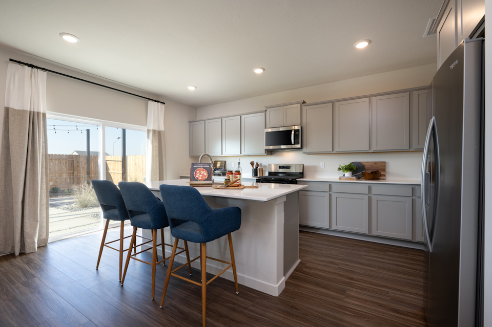 A kitchen with white cabinets.
