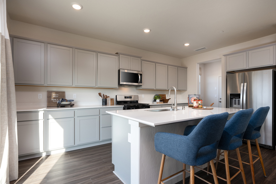 A kitchen with white cabinets.
