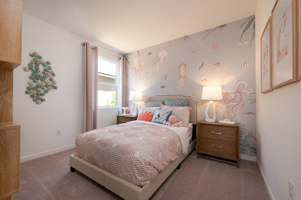 A bedroom with a bed and lamps.