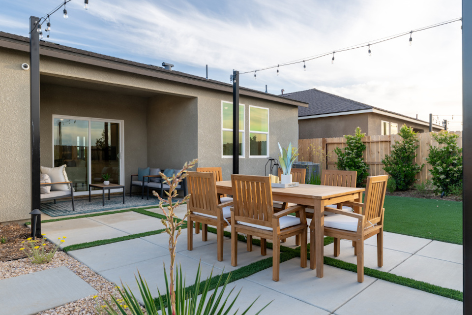 A patio with a table and chairs.