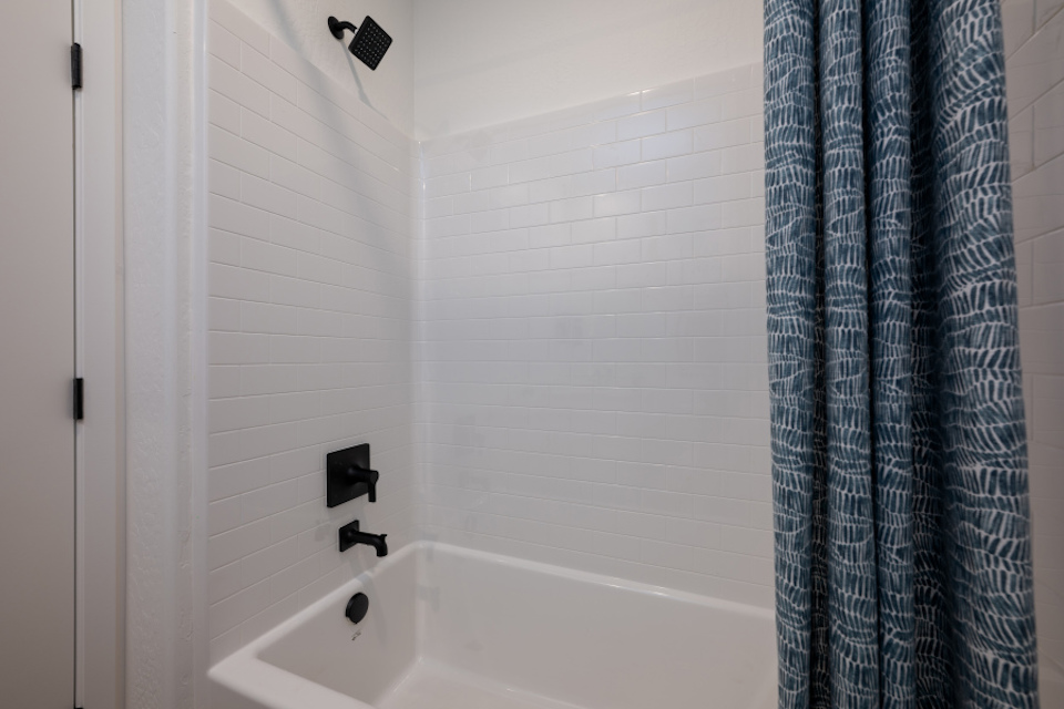 A bathtub in a bathroom.