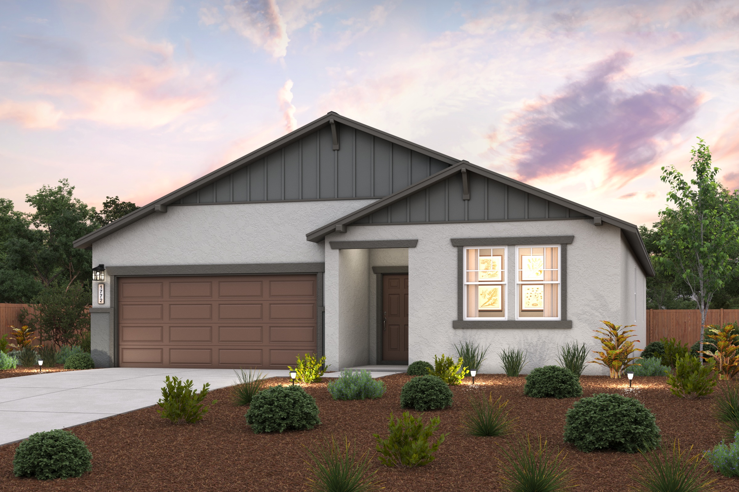 A house with a garage and bushes.