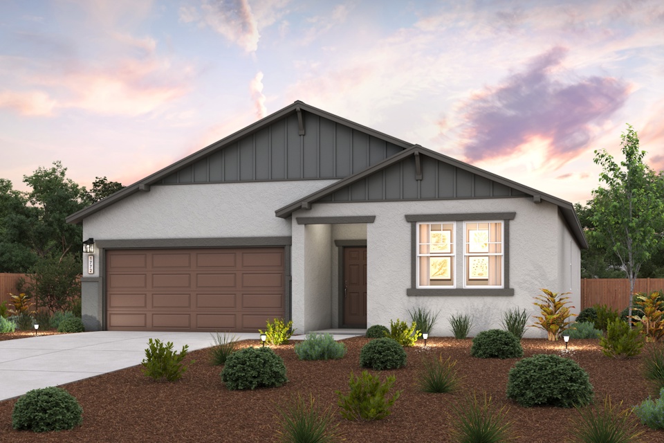 A house with a garage and bushes.