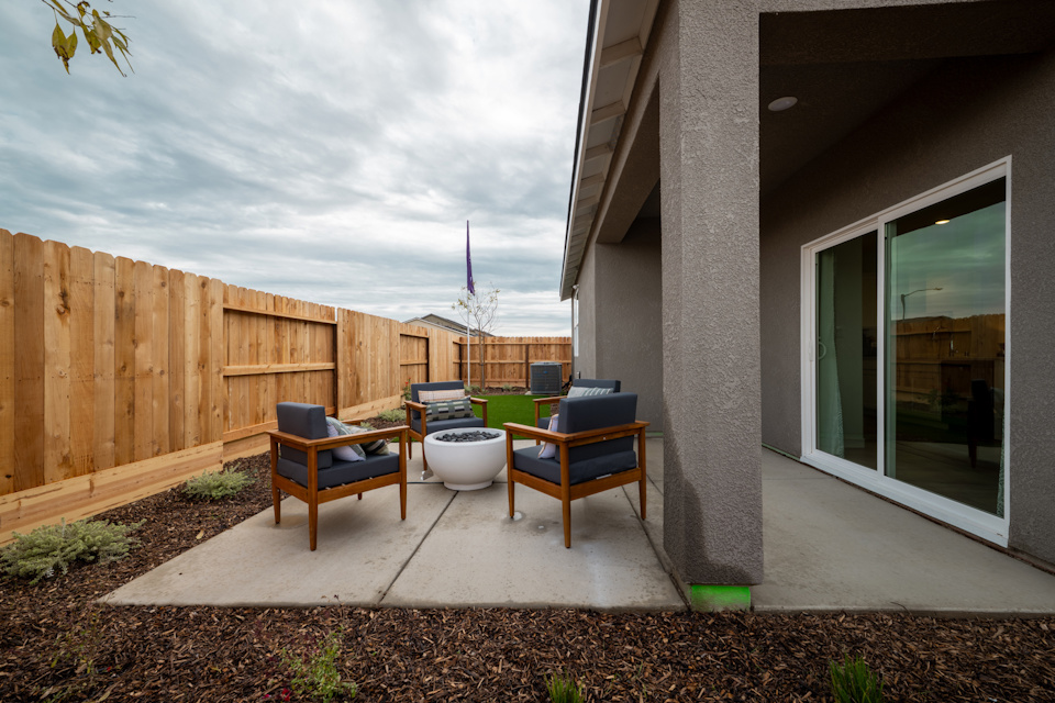 A patio with a table and chairs.