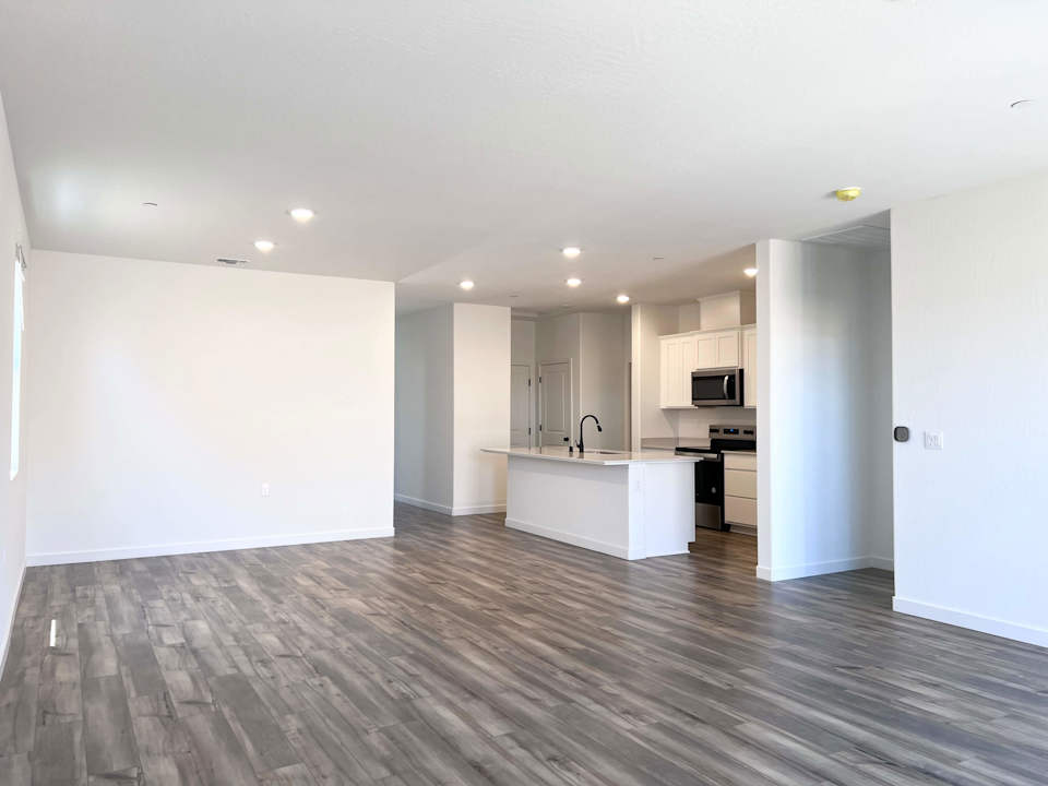 A large kitchen with white walls.